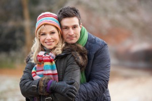 Couple On Romantic Winter Walk Through Frosty Landscape